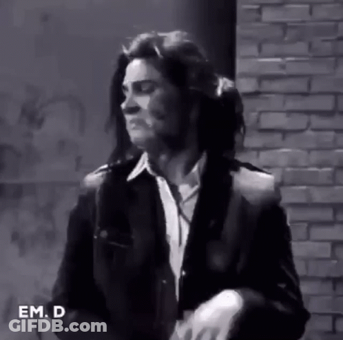 Man In Suit And Tie In Front Of Brick Wall GIF