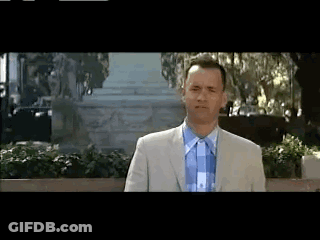 Man In Suit And Tie In Front Of Building GIF