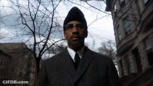 Man In Suit And Tie In Front Of Building GIF