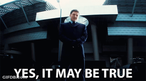 Man In Suit And Tie In Front Of Building GIF