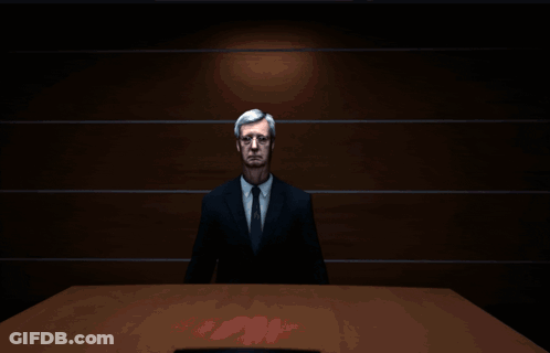 Man In Suit And Tie In Front Of Circle Of Light GIF