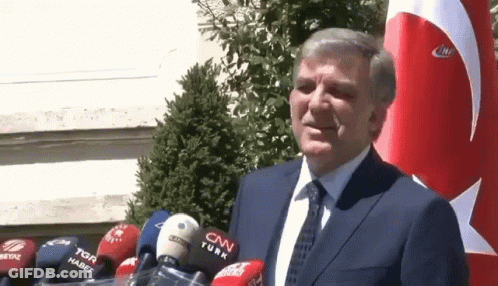 Man In Suit And Tie In Front Of CNN Turk Microphones GIF
