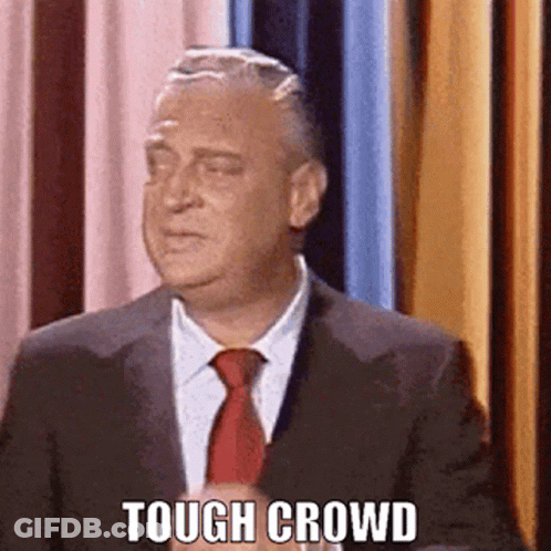 Man In Suit And Tie In Front Of Curtain Tough Crowd GIF