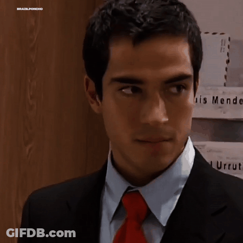 Man In Suit And Tie In Front Of Endez G Wall GIF