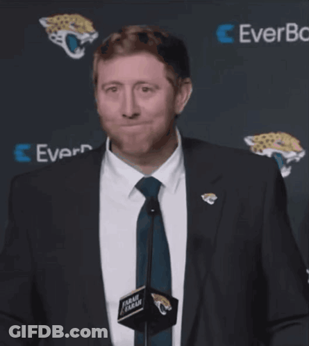 Man In Suit And Tie In Front Of EverBank Sign GIF