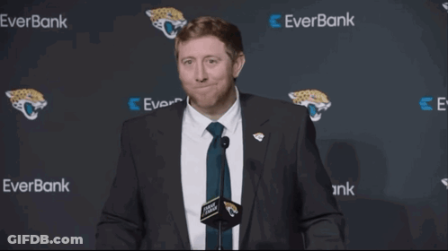 Man In Suit And Tie In Front Of Everbank Wall GIF