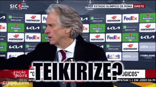 Man In Suit And Tie In Front Of FedEx Backdrop GIF