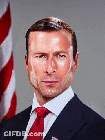Man In Suit And Tie In Front Of Flag GIF