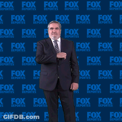 Man In Suit And Tie In Front Of Fox Deportes Backdrop GIF