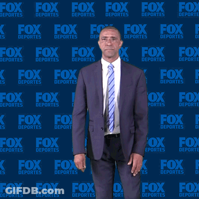 Man In Suit And Tie In Front Of Fox Deportes Backdrop GIF