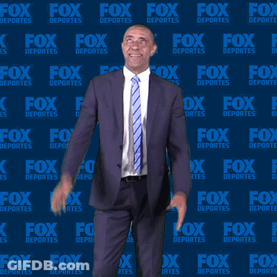 Man In Suit And Tie In Front Of Fox Deportes Background GIF