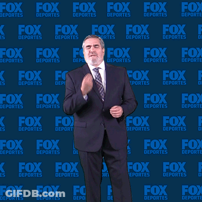 Man In Suit And Tie In Front Of Fox Deportes Wall GIF