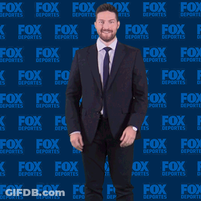 Man In Suit And Tie In Front Of Fox Deportes Wall GIF