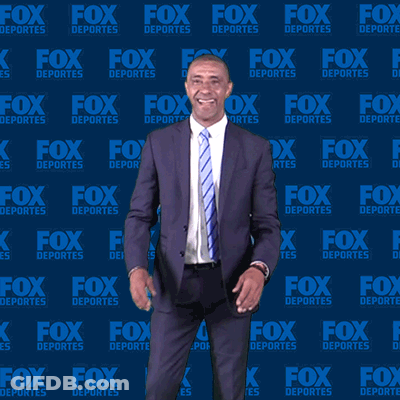 Man In Suit And Tie In Front Of Fox Deportes Wall GIF