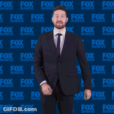 Man In Suit And Tie In Front Of Fox Deportes Wall GIF