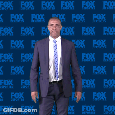 Man In Suit And Tie In Front Of Fox Deportes Wall GIF