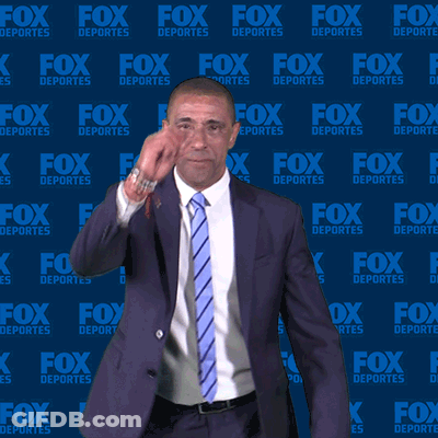 Man In Suit And Tie In Front Of Fox Deportes Wall GIF
