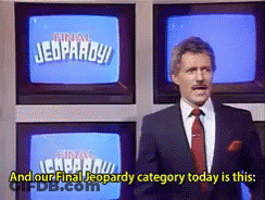 Man In Suit And Tie In Front Of Jeopardy Screen GIF