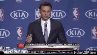 Man In Suit And Tie In Front Of Kia Logo GIF