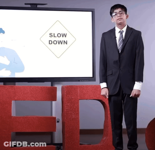 Man In Suit And Tie In Front Of Large TED Sign GIF