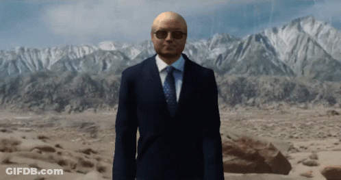 Man In Suit And Tie In Front Of Mountains GIF