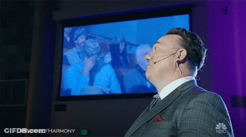 Man In Suit And Tie In Front Of NBC Screen GIF
