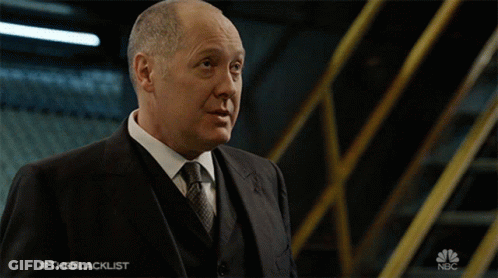 Man In Suit And Tie In Front Of NBC Sign GIF