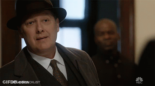 Man In Suit And Tie In Front Of NBC Sign GIF