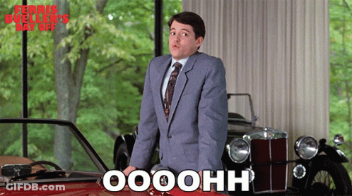 Man In Suit And Tie In Front Of Red Car Saying Oooohh GIF