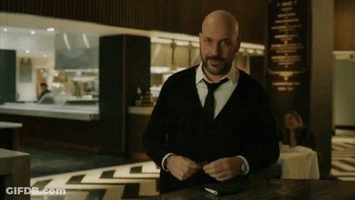 Man In Suit And Tie In Front Of Restaurant GIF
