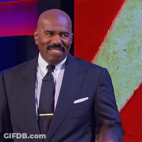 Man In Suit And Tie In Front Of Screen GIF