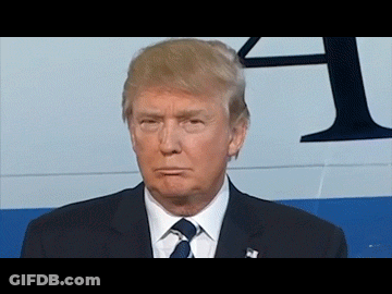 Man In Suit And Tie In Front Of Sign Saying A GIF