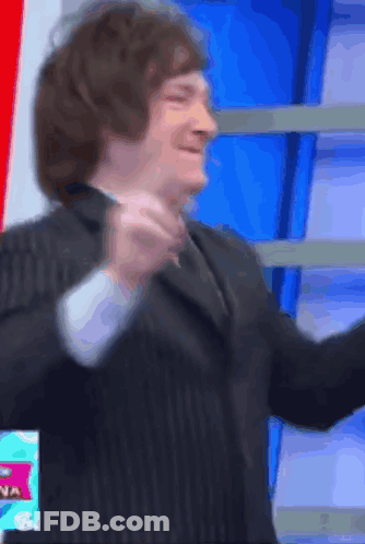 Man In Suit And Tie In Front Of Sign Saying Na GIF