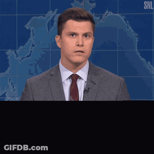 Man In Suit And Tie In Front Of SNL Map GIF