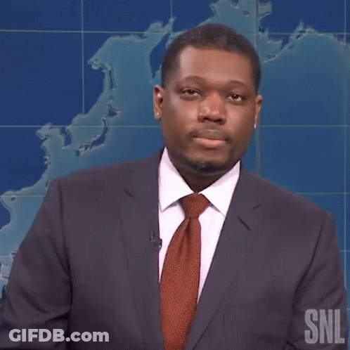 Man In Suit And Tie In Front Of SNL Map GIF