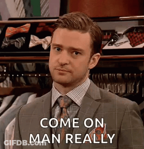 Man In Suit And Tie In Front Of Tie Display GIF