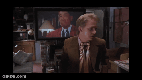 Man In Suit And Tie In Front Of TV Saying McBride GIF