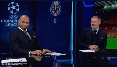 Man In Suit And Tie In Front Of UEFA Logo GIF