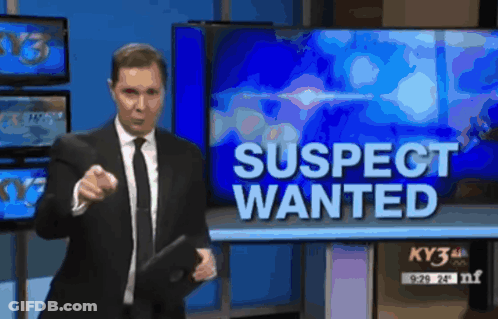 Man In Suit And Tie In Front Of Wanted Sign GIF