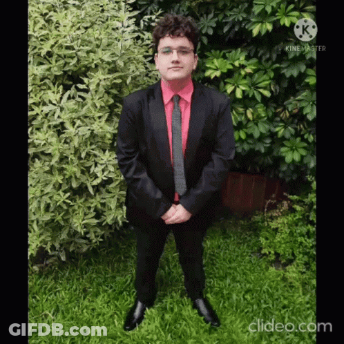 Man In Suit And Tie In Grass With Folded Hands GIF