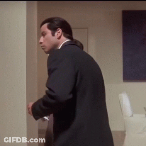 Man In Suit And Tie In Hallway GIF