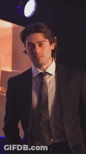 Man In Suit And Tie In Spotlight GIF