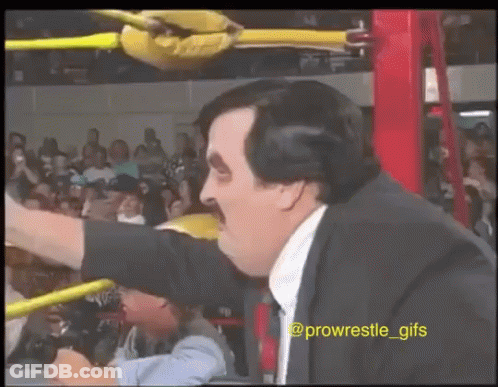 Man In Suit And Tie In Wrestling Ring Arm Outstretched GIF