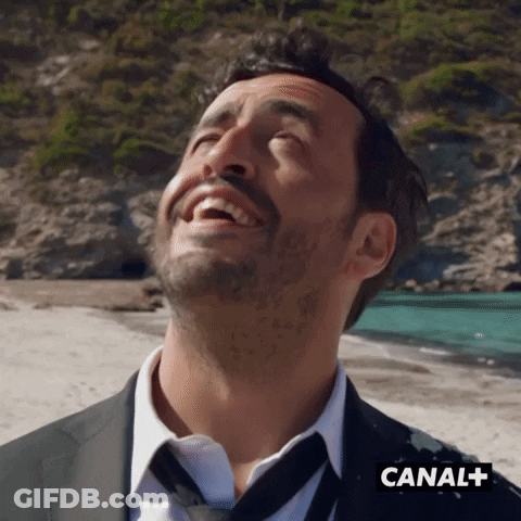 Man In Suit And Tie Laughing At Canal+ GIF