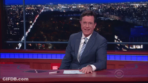 Man In Suit And Tie Laughing At Desk GIF