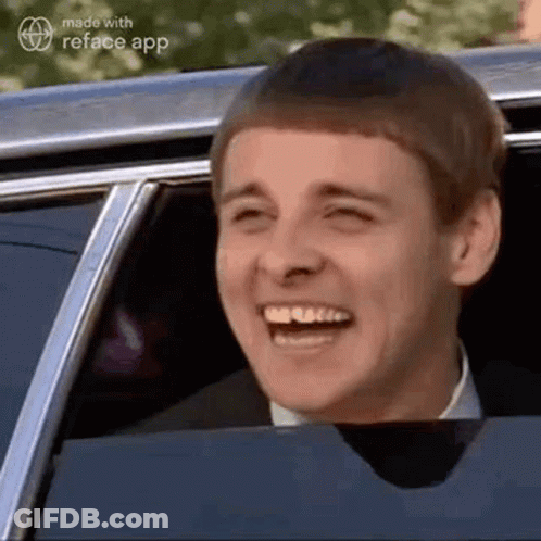Man In Suit And Tie Laughing In Car GIF