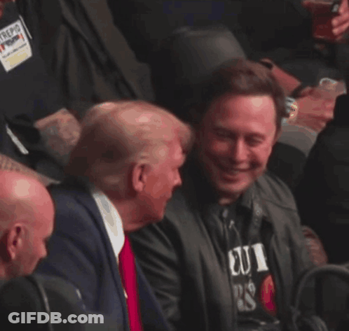 Man In Suit And Tie Laughing In Crowd GIF