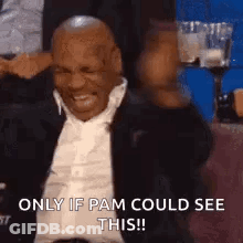 Man In Suit And Tie Laughing In Stadium GIF