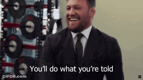 Man In Suit And Tie Laughing Says Youll Do What Youre Told GIF