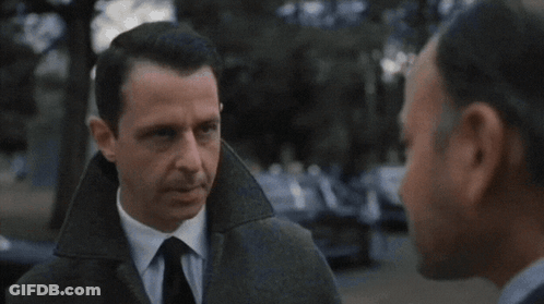 Man In Suit And Tie Looking At Another Man GIF